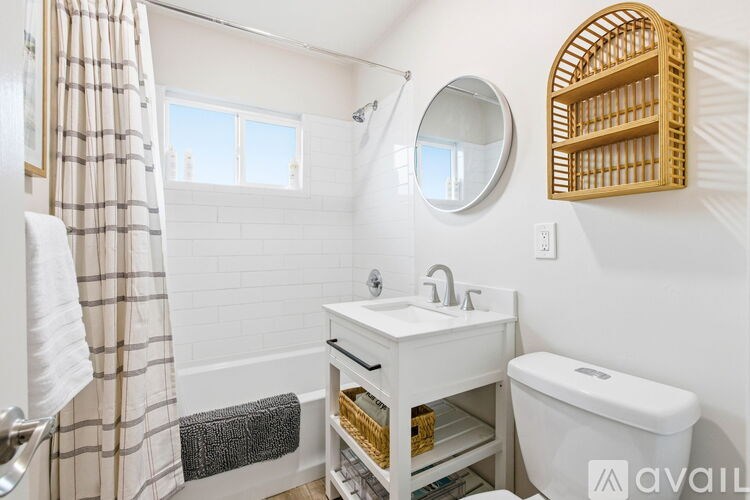 A bathroom with a white sink and toilet.