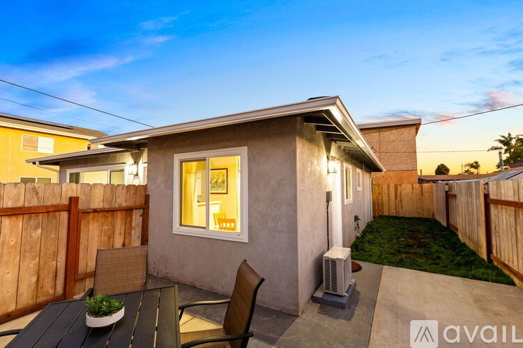 A patio with a table and chairs is set up outside a house.