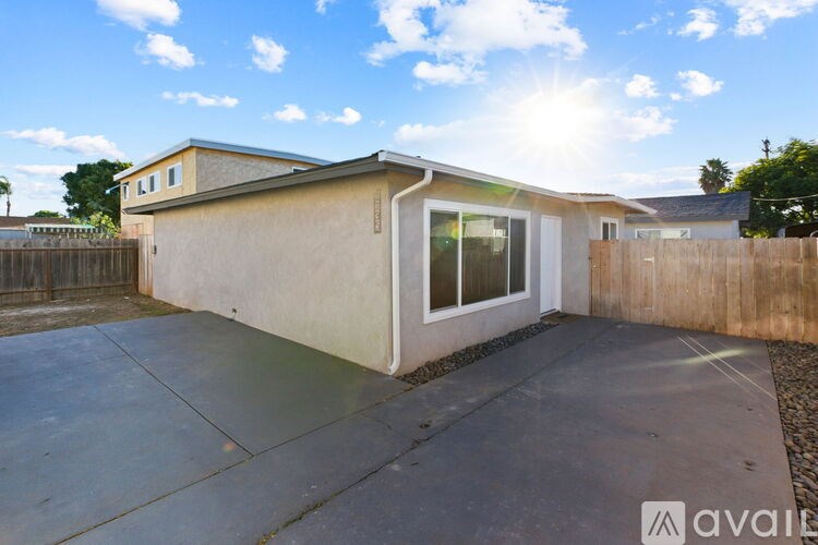 A house with a beige exterior and a white window is for sale.