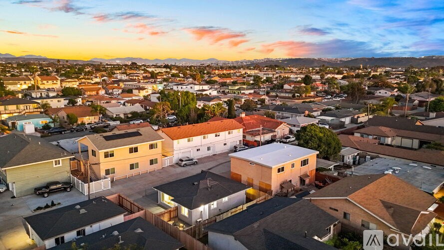 A sunset view of a residential neighborhood with houses and streets.