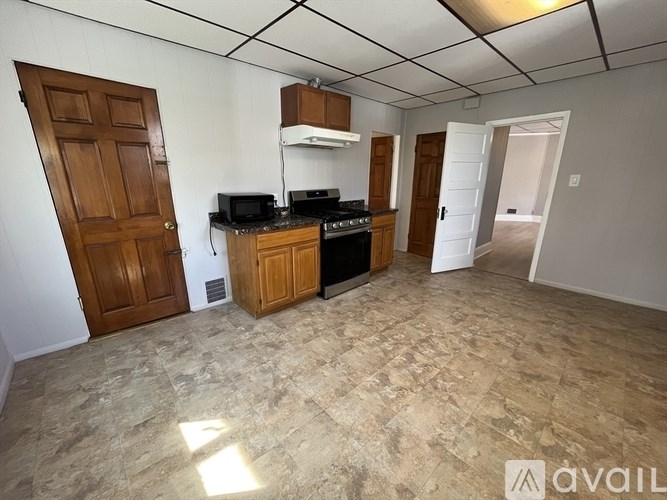 A kitchen area with a counter, oven, and microwave.