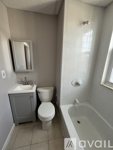A bathroom with a toilet, sink, and bathtub.