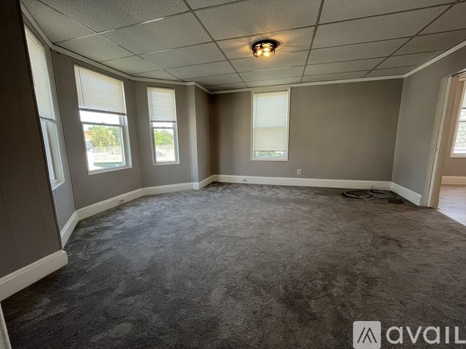 A room with a carpeted floor and a ceiling light.