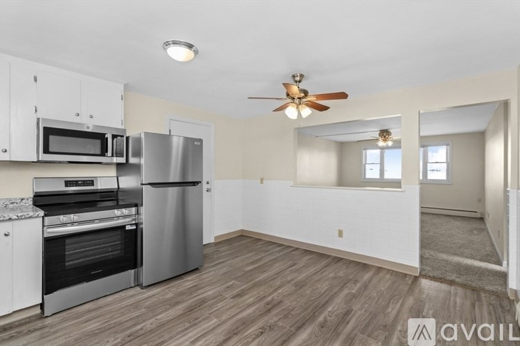 A kitchen with a stainless steel refrigerator, oven, and microwave.