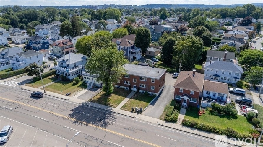 A bird's eye view of a residential area with houses and cars.