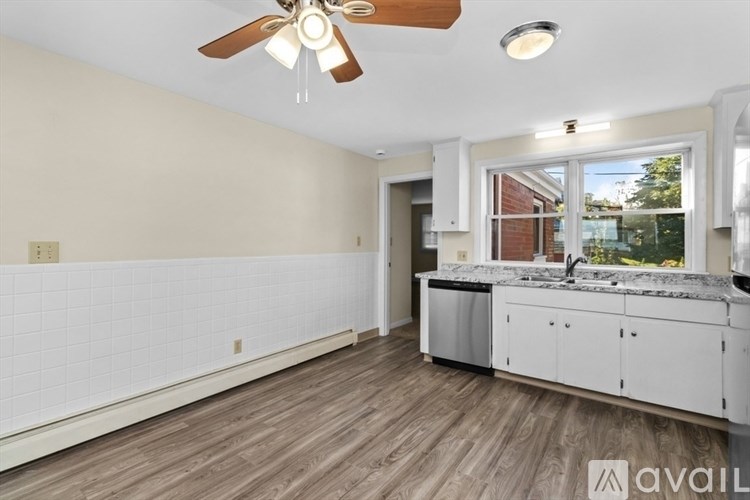 A kitchen with a fan and a window.