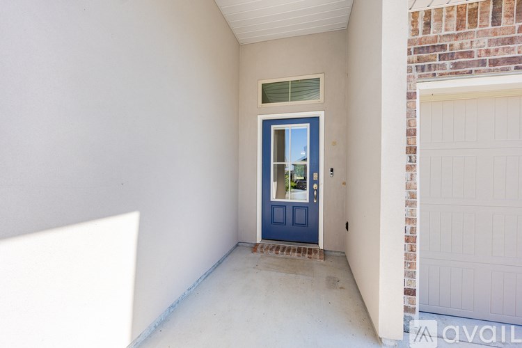 A blue door is in a white wall.