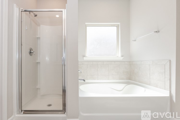 A white bathroom with a tub and shower.