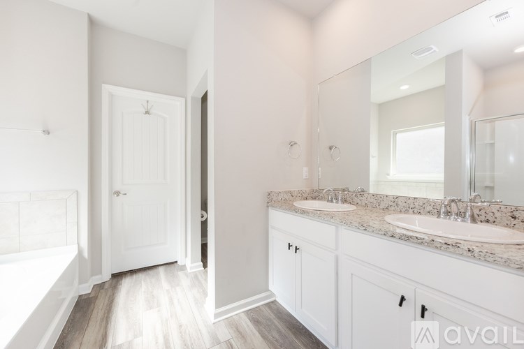 A bathroom with a white tub and sink.