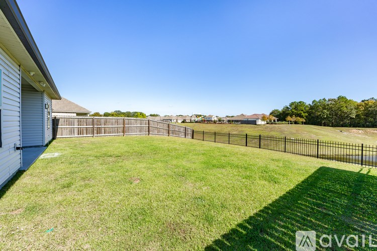 A backyard with a fence and a shed.