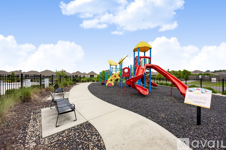 A playground with a red slide and a yellow tower.