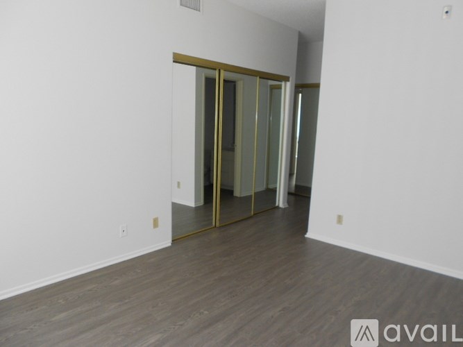 A room with a wooden floor and a sliding glass door.