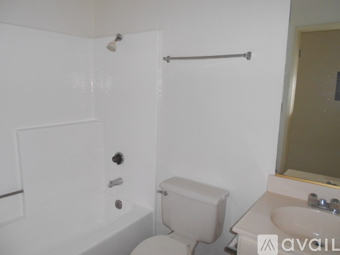 A white toilet is in a small bathroom.