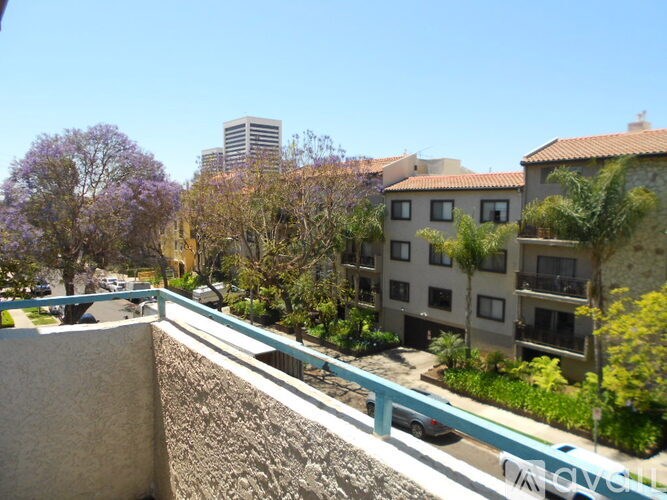 A view of a residential area with apartment buildings and trees.