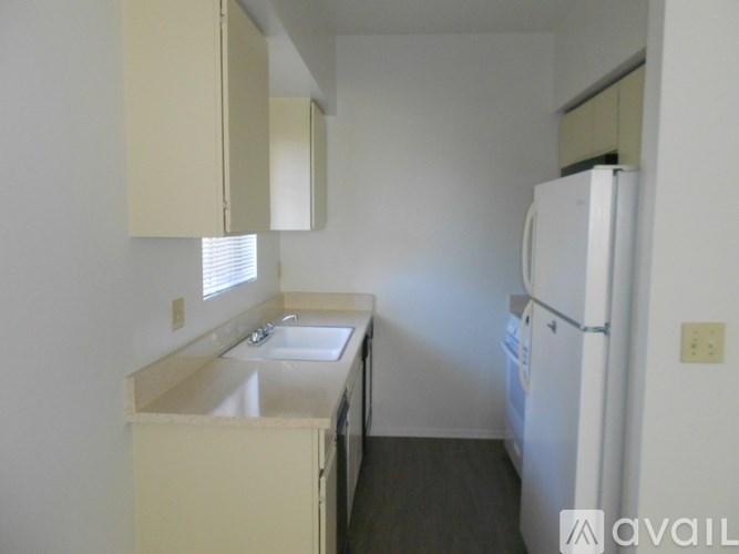 A small kitchen with a sink and a refrigerator.