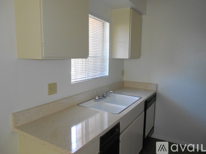 A kitchen with a sink and a window.