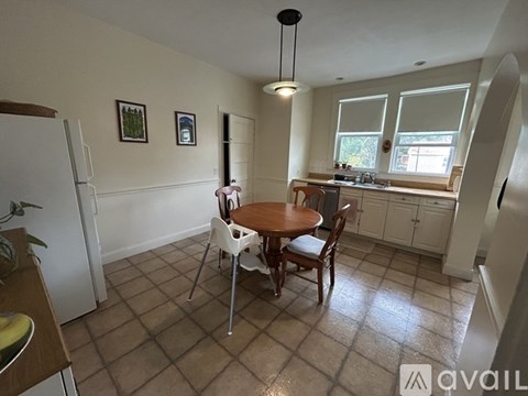 A kitchen with a table and chairs in the middle of the room.