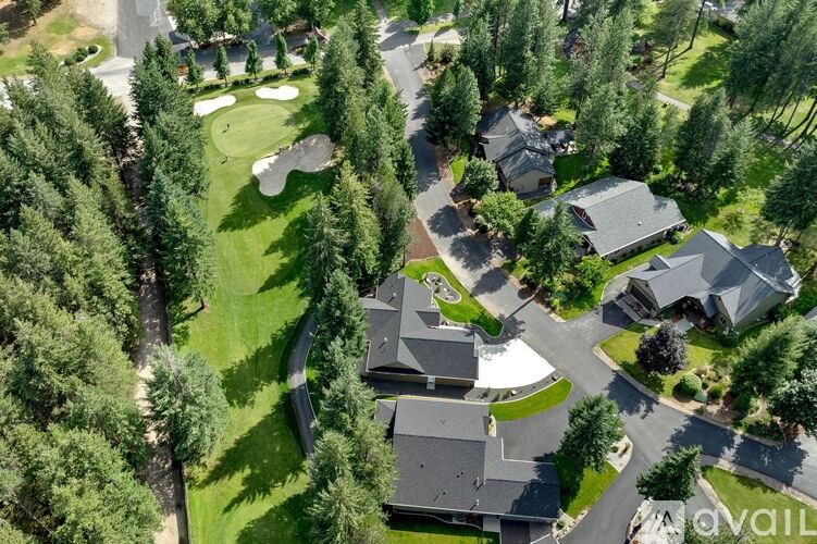 A bird's eye view of a residential area with houses and greenery.