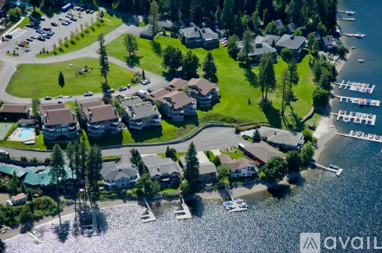 A bird's eye view of a residential area with houses, boats, and a swimming pool.