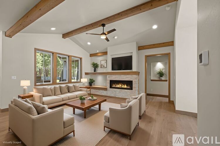 A modern living room with a fireplace and a television.
