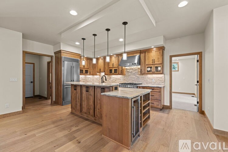 A modern kitchen with wooden cabinets and a central island.