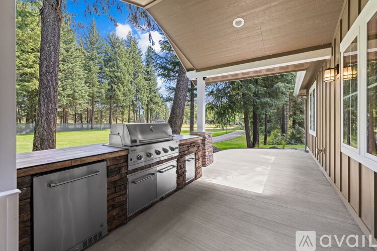 A wooden deck with a grill and a washing machine.