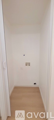 A small, empty room with a light switch on the wall.