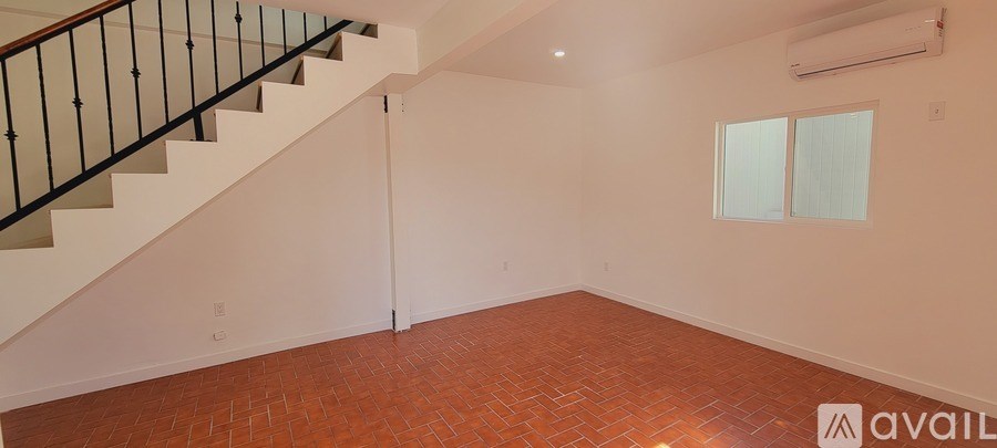 A room with a staircase and a window.