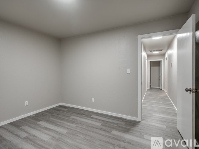 A long hallway with a door on the right.