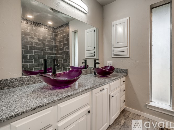 A bathroom with two sinks and a large mirror.