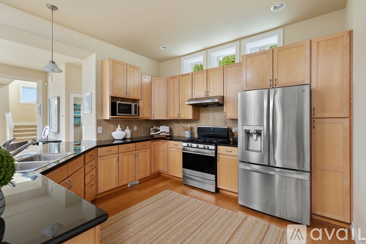 A kitchen with wooden cabinets and stainless steel appliances.