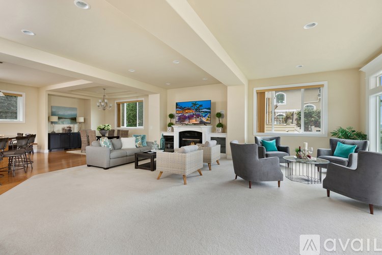 A spacious living room with a fireplace and comfortable seating.