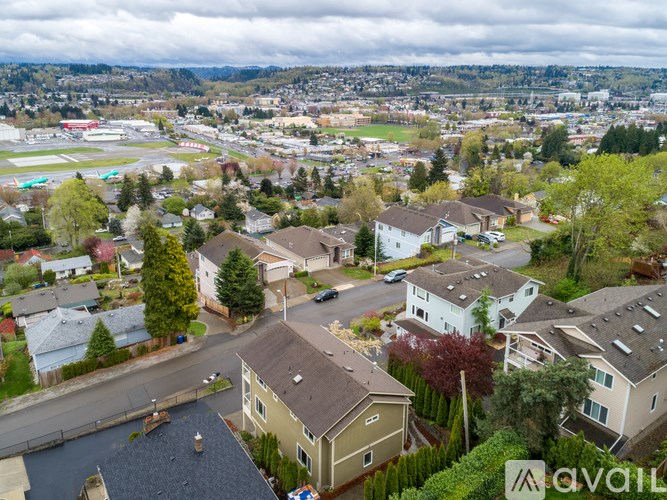 A suburban neighborhood with houses and a road.