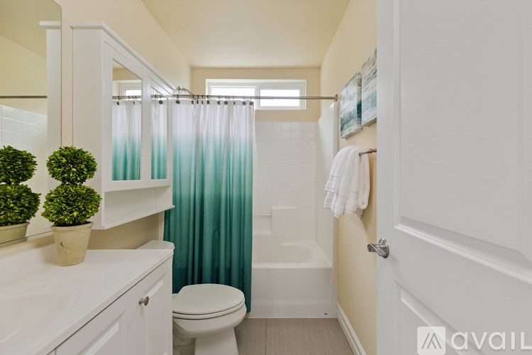 A bathroom with a toilet, sink, and shower.
