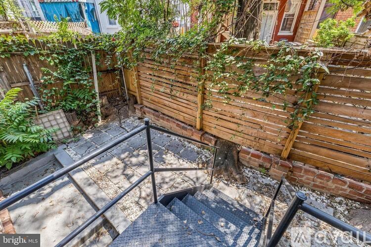 A wooden fence with green plants growing on it.