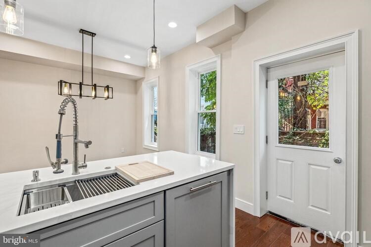 A kitchen with a marble countertop and a window.