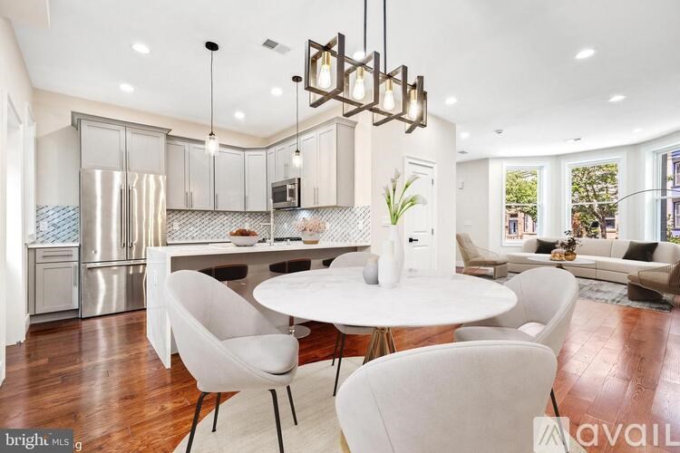 A modern kitchen with a dining table and chairs.