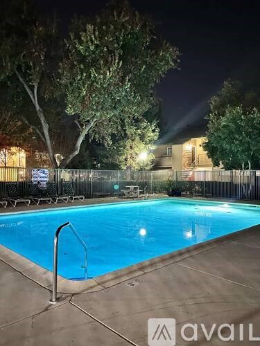 A pool at night with lights on.