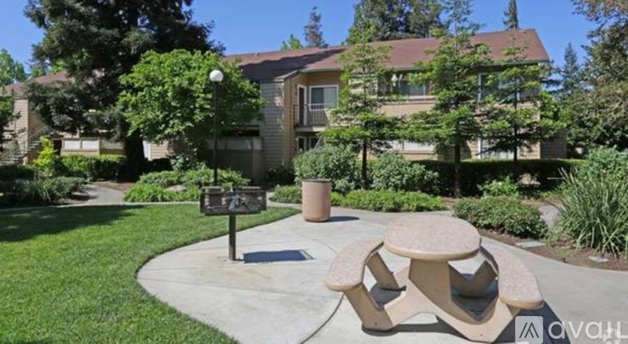 A park with a bench and a sign.