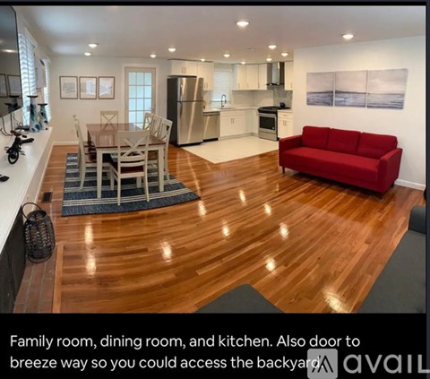 A modern kitchen with a dining table and chairs in the middle of the room.