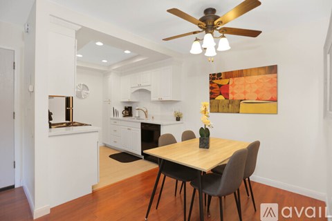 A dining room with a wooden table and chairs.