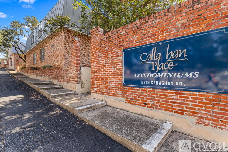 A brick wall with a sign that says Callahan Place Condominiums.