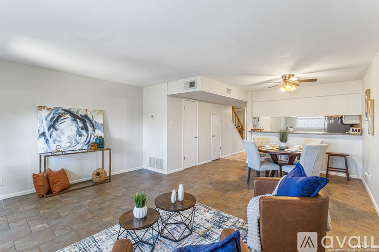 A living room with a brown couch and a coffee table.