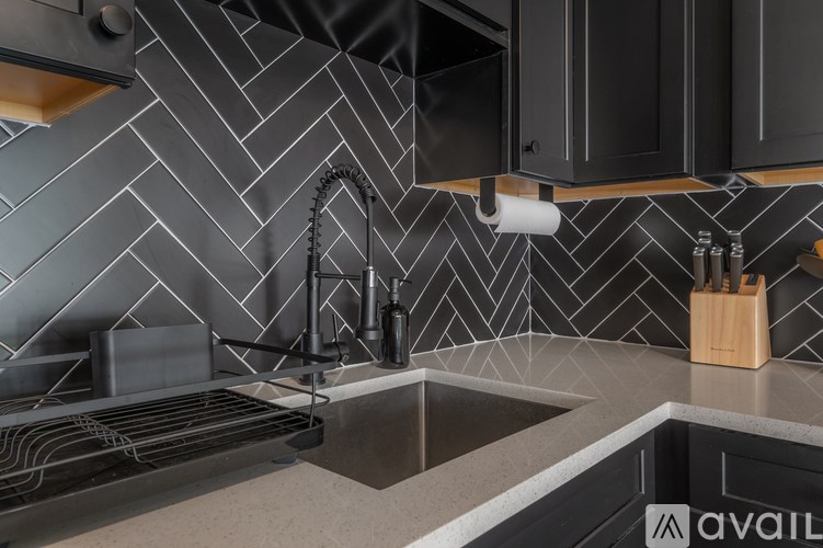 A kitchen with a sink and a stove top.