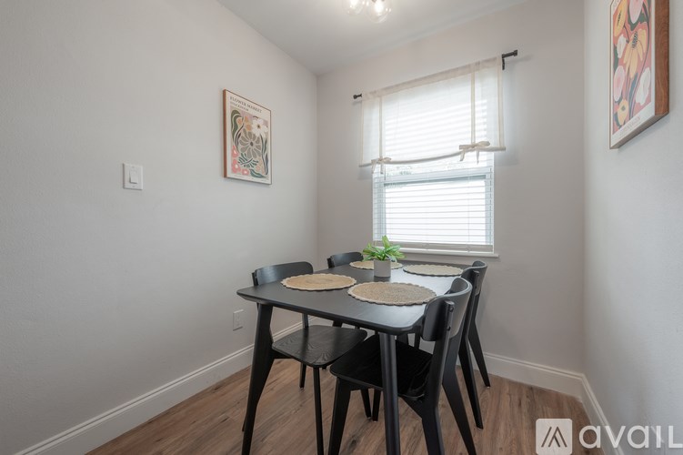 A dining area with a table and chairs.