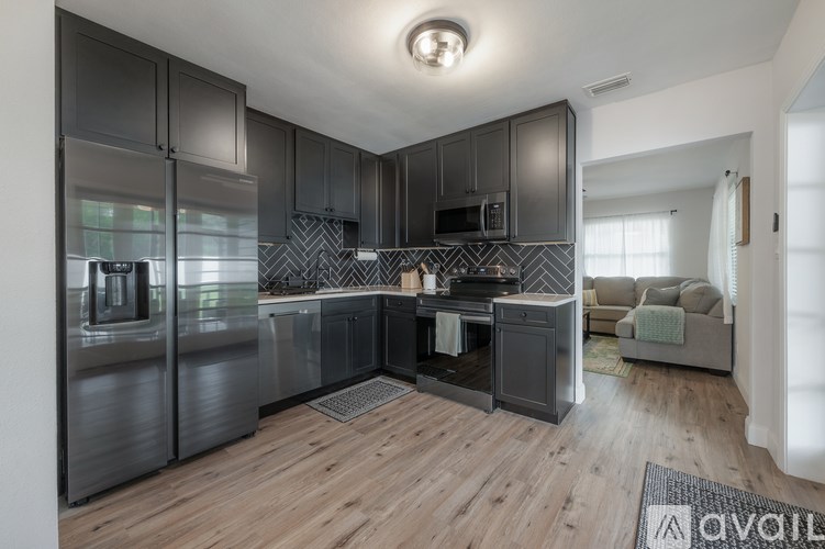 A modern kitchen with dark wood cabinets and a central island.