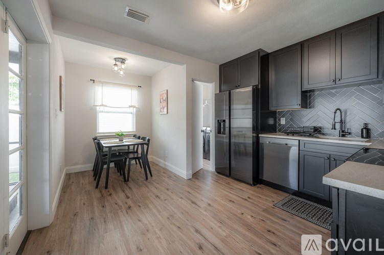 A kitchen with a table and chairs in the middle of the room.