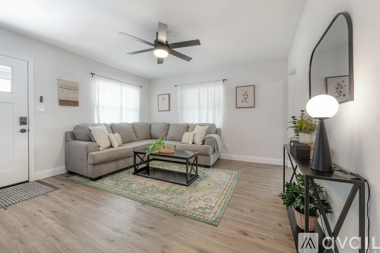 A living room with a grey sofa and a coffee table.