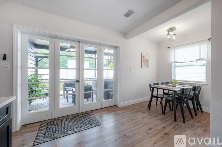 A dining room with a table set for four.