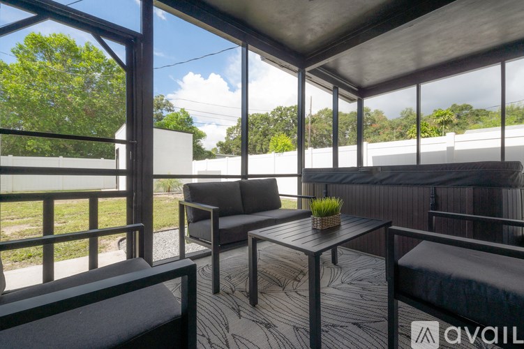 A modern outdoor seating area with a view of the trees and sky.